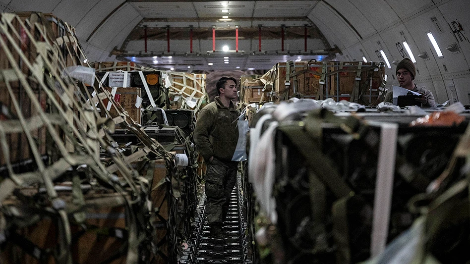 Airmen attached to the 436th Aerial Port Squadron check cargo logs during a security assistance mission at Dover Air Force Base